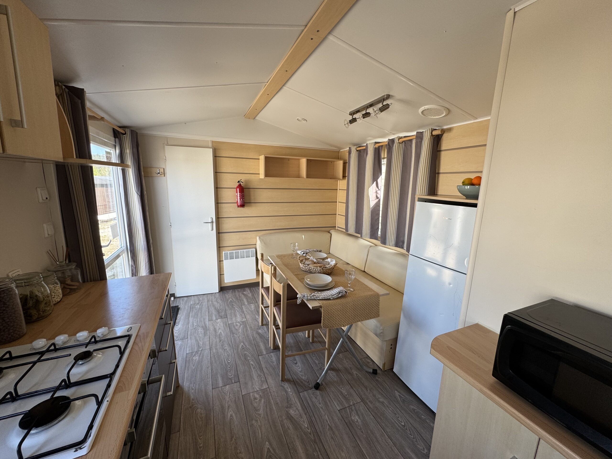 IRM Villanova 4 Salón-comedor y cocina de un mobil home, con sofá y mesa